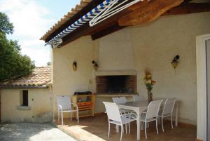 eine Terrasse mit einem Tisch und Stühlen auf einem Haus in der Unterkunft L'oustau des euses in Bédoin