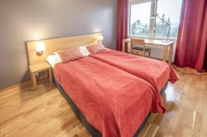a bedroom with a bed with a red blanket at Ruka Ski Chalets in Ruka
