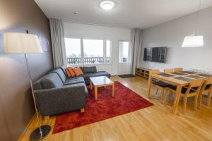 a living room with a couch and a table at Ruka Ski Chalets in Ruka