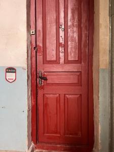 a red door on a building with a sign on it at Enjoy Georgian Regions in Tʼetʼri Tsqaro