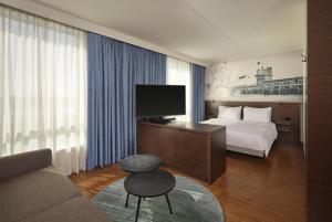 a hotel room with a bed and a television at Park Plaza Amsterdam Airport in Lijnden
