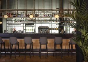 a bar with four stools in a restaurant at Park Plaza Amsterdam Airport in Lijnden +47 photos