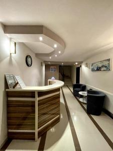 a lobby with a reception desk and a hallway at Silistar Hotel in Rezovo