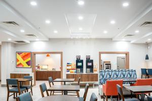a restaurant with tables and chairs in a room at Holiday Inn Express and Suites Saint Augustine North by IHG in St. Augustine