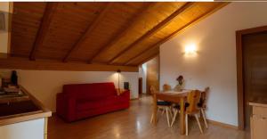 a living room with a red couch and a table at Ferienhof Blaas in Malles Venosta