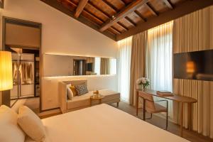 a hotel room with a bed and a desk at Domus Teatro di Pompeo in Rome