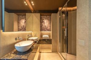 a bathroom with a sink and a glass shower at Domus Teatro di Pompeo in Rome