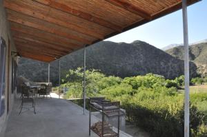 a porch with a view of the mountains at Schuilhoek Cottage - Your perfect hide away! in Calitzdorp