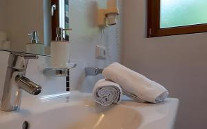 a towel sitting on top of a bathroom sink at Ferienhof Blaas in Malles Venosta +57 photos