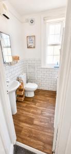 a white bathroom with a toilet and a sink at A View Of The Bay- Close to Margate - Sleeps 3 in Westgate-on-Sea +37 photos