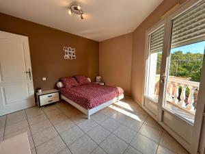 a bedroom with a bed and a large window at Villa à Pyla-sur-Mer avec piscine in La Teste-de-Buch +18 photos