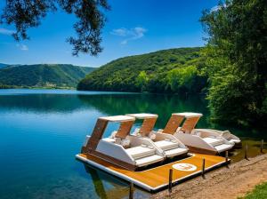 a group of chairs sitting on a dock on a lake at Motel Gilau in Gilău +22 photos