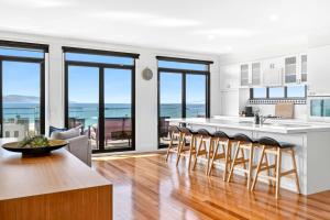 a kitchen and living room with a view of the ocean at Marram House - Views in Marengo in Marengo +15 photos