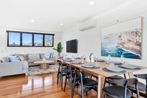 a living room with a table and chairs and a couch at Marram House - Views in Marengo in Marengo