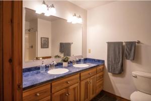 a bathroom with two sinks and a large mirror at Agape Aldea in Jamestown +49 photos