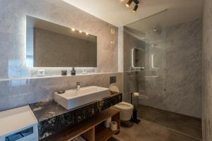 a bathroom with a sink and a toilet and a mirror at Mama Boutique Apartment in Krušetnica +38 photos