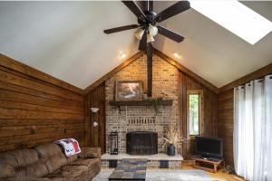 a living room with a ceiling fan and a fireplace at Agape Aldea in Jamestown