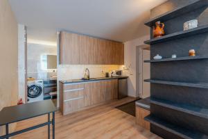 a kitchen with wooden cabinets and a counter top at Mama Boutique Apartment in Krušetnica