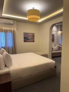 a bedroom with a large bed and a couch at IOS Village & Hotels in El Alamein