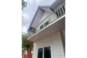 a house with a balcony on top of it at FabHotel Hill View Cottages in Arpora +8 photos