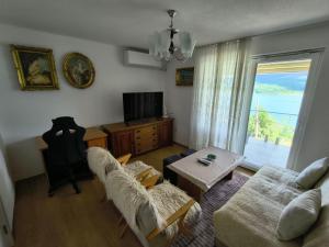 a living room with a couch and a table at Villa Nena in Mavrovi Anovi