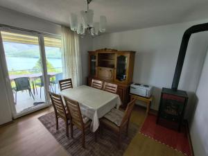 a dining room with a table and a wood stove at Villa Nena in Mavrovi Anovi
