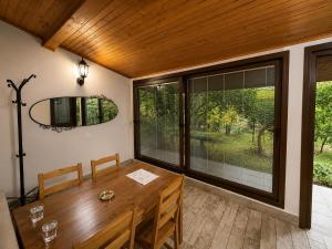 a dining room with a table and a large window at Motto Polonezköy in Beykoz
