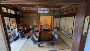 a dining room with a table and chairs in it at Ikada in Amami