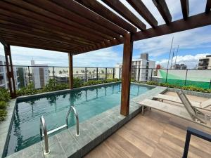 a swimming pool on the roof of a building at Flat Praiano Intermares Boutique in Cabedelo