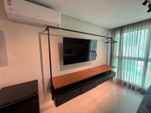 a living room with a flat screen tv on a wall at Flat Praiano Intermares Boutique in Cabedelo