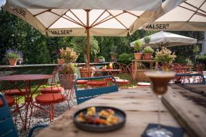 a wooden table with a bowl of food on top of it at Villa Beaulieu in St. Moritz