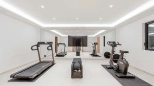 a gym with treadmills and elliptical machines at Villa Trois-Pins in Ramatuelle
