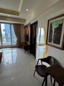 a living room with a chair and a table at Elysium Tower Luxury Apartments Islamabad Opposite Centaurus Mall in Islamabad