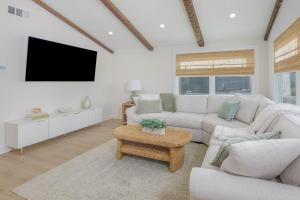 a living room with a couch and a tv at Mermaid Lane #2 in Brighton Beach