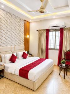 a bedroom with a large bed with red pillows at Holiday One Hotel & Suites - Gulshan-3 in Karachi +30 photos