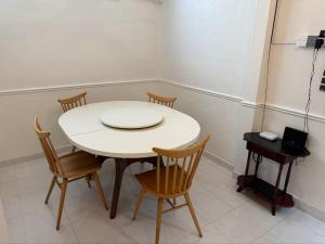a white table and chairs in a room at 8minit walk to jongke in Malacca