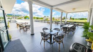 a restaurant with tables and chairs on a patio at Airport Hotel - Baia Mare - Maramures in Baia Mare