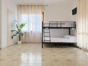 a bedroom with two bunk beds and a potted plant at Only Teens - Baia Verde in Baia Verde +38 photos