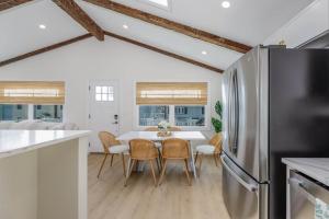 a kitchen and dining room with a table and a refrigerator at Mermaid Lane #2 in Brighton Beach +14 photos
