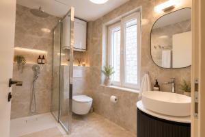 a bathroom with a sink toilet and a shower at Villa Mater in Trogir