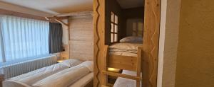 a room with two bunk beds and a window at Schwaben Resort Ebnisee in Ebni +20 photos