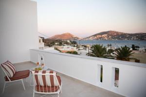 a balcony with a view of the ocean and mountains at Aellia Bay Residences in Alinda +10 photos