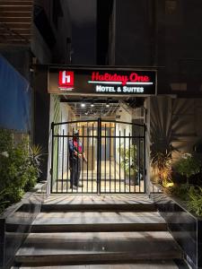 an entrance to a hotel and suites with an open gate at Holiday One Hotel & Suites - Gulshan-3 in Karachi