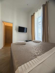 a bedroom with a large bed with two towels on it at DOMUS LUIGI LEONE 2 in Naples