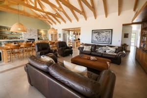 a large living room with leather furniture and a kitchen at Farmstead at ECS winery in Lake Marina