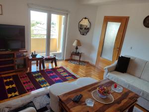 a living room with a couch and a table at Pansion Ajlin in Blagaj +24 photos
