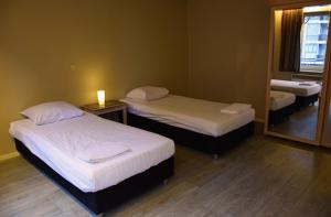 Postel nebo postele na pokoji v ubytování Ambassador Suites Antwerp