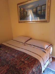 a bed in a room with a picture on the wall at VILLA flora e Riccardo in Fara San Martino +11 photos
