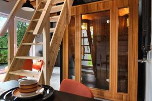 a tiny house with a staircase and a dining room at Natura Taszów in Lewin Kłodzki