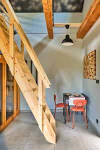 a dining room with a table and a staircase at Natura Taszów in Lewin Kłodzki